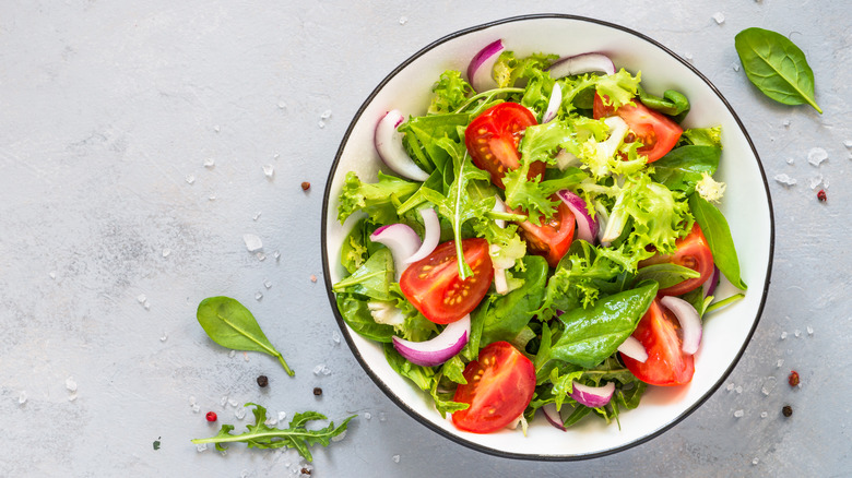 Salad in a white bowl on a grey table