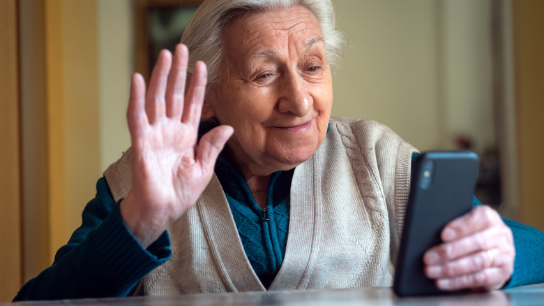 Happy grandmother looking at her phone