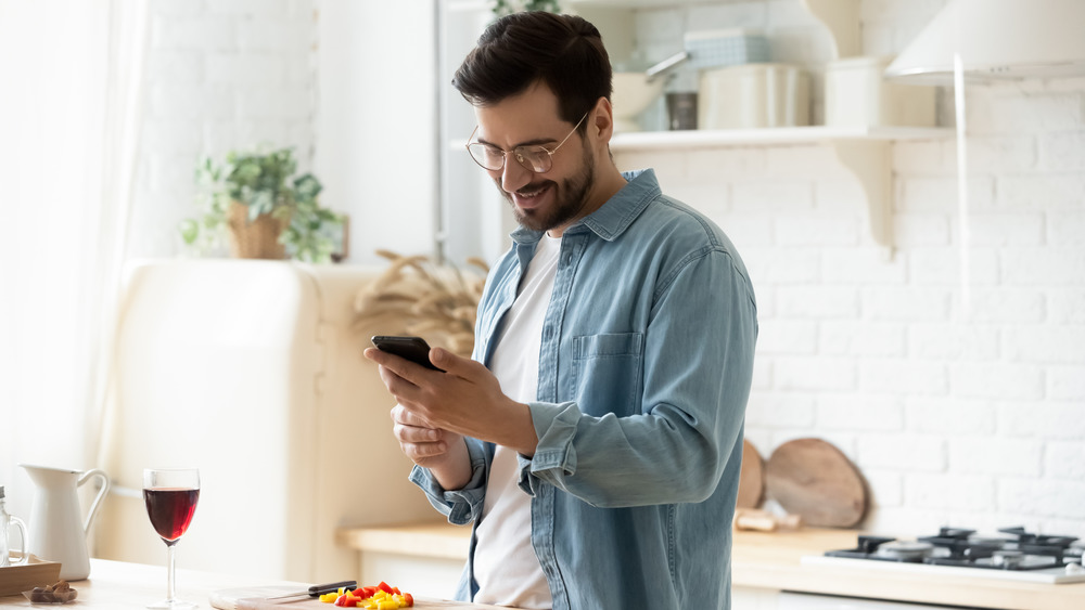 Man meal planning in his kitchen