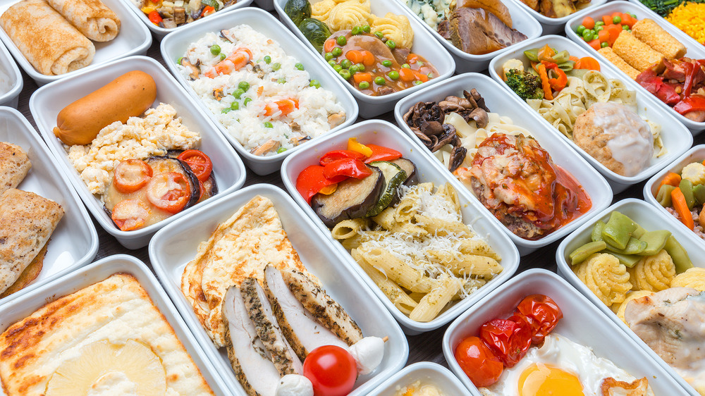 Many containers of meal prepped food on a table