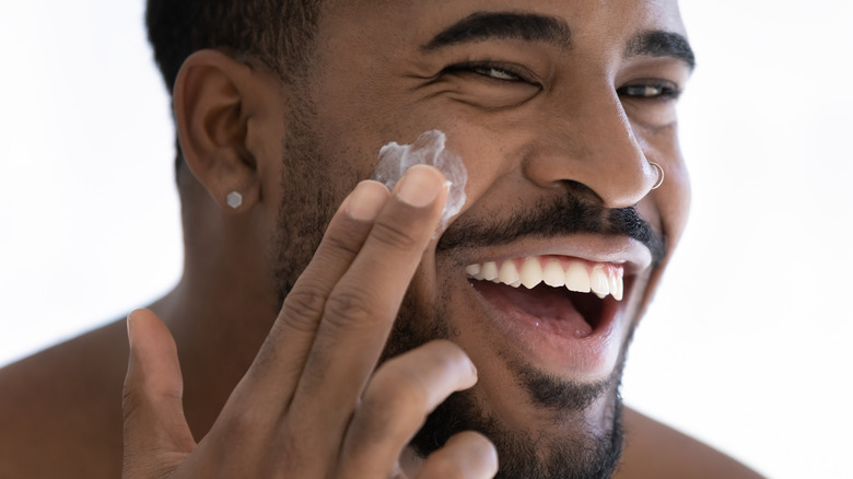 happy guy doing skincare