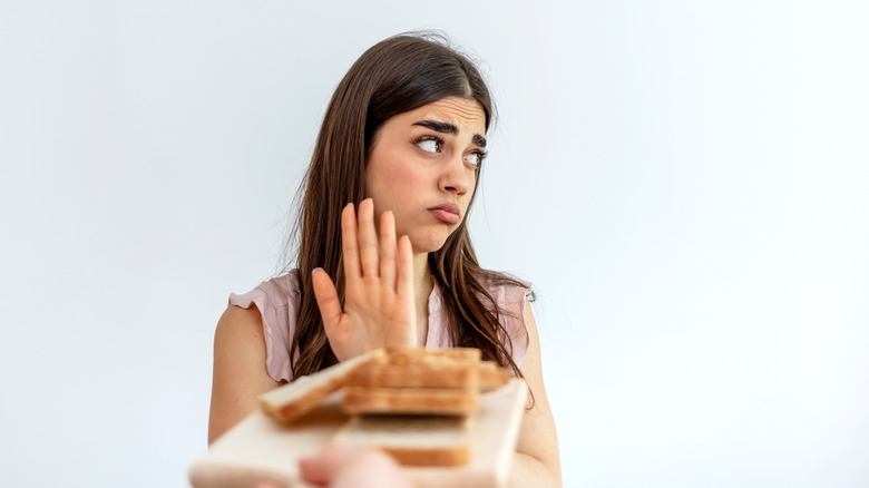 woman turning down bread