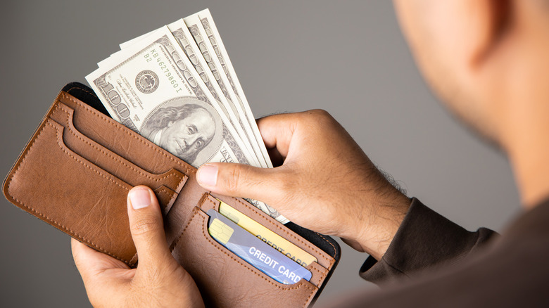 Man taking money out of wallet