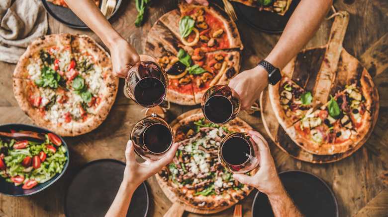 Top-down view of people eating and drinking at a dinner party