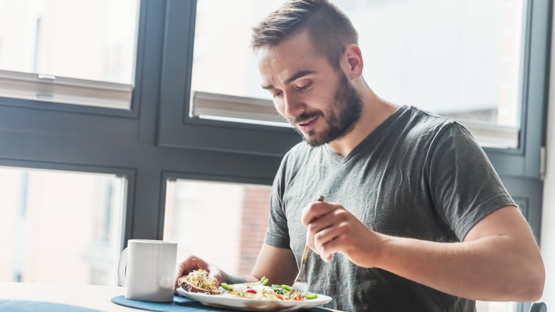 Man eating breakfast in the kitchen