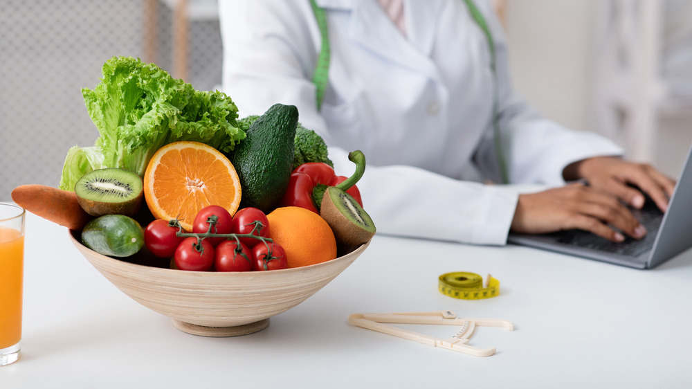 Nutritionist blogging next to fresh food