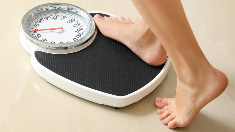 woman stepping on the scale 