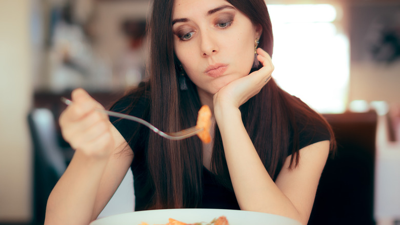 unhappy woman eating restricted diet