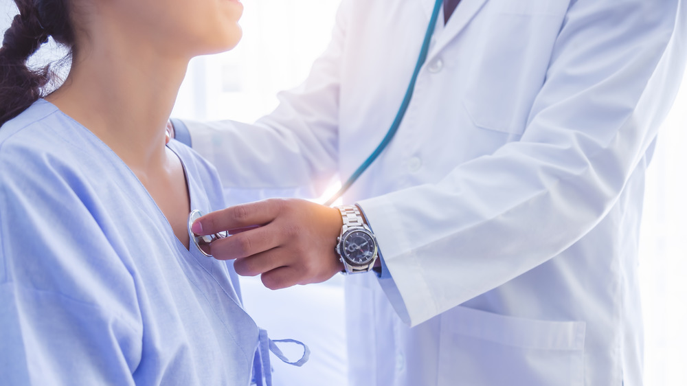 Doctor using a stethoscope on a patient