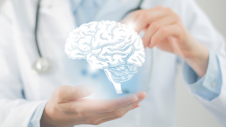 doctor holding up image of brain