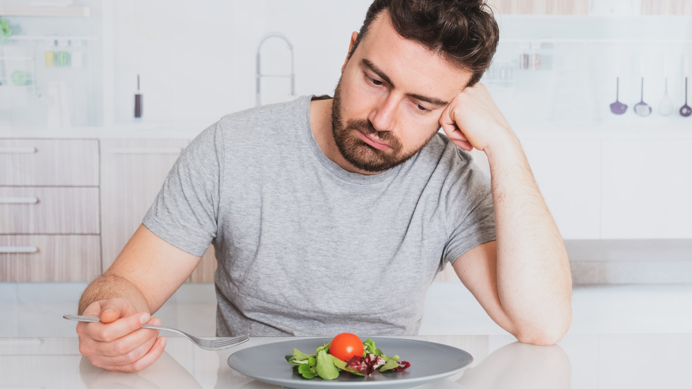 Sad man looking at plate