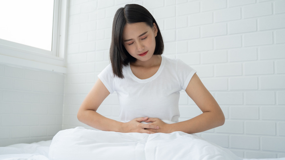 Woman holding stomach