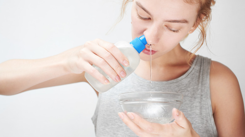 woman using saline solution with bowl