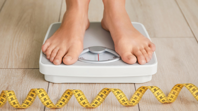 woman measuring weight at home 