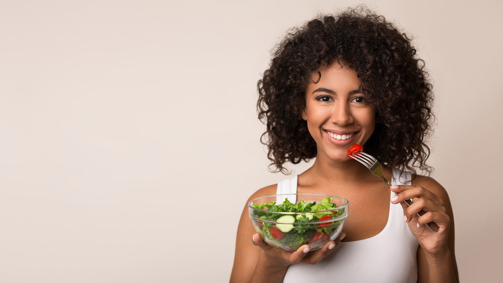 Woman eating and looking happy