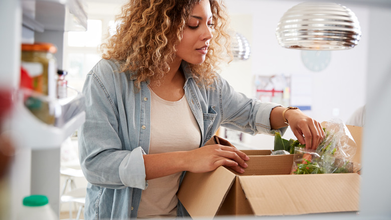 woman unpacking meal delivery kit