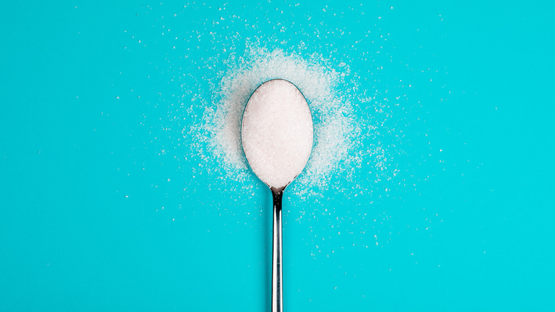 Artificial sweetener granules on spoon