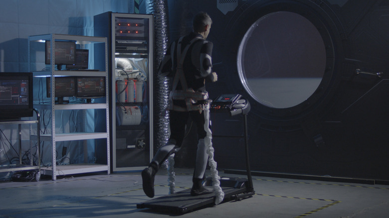 Astronaut on treadmill in space station