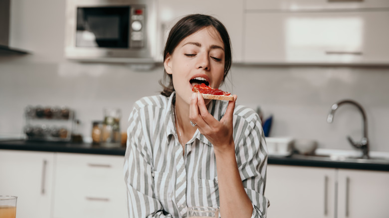 woman eating a piece of toast