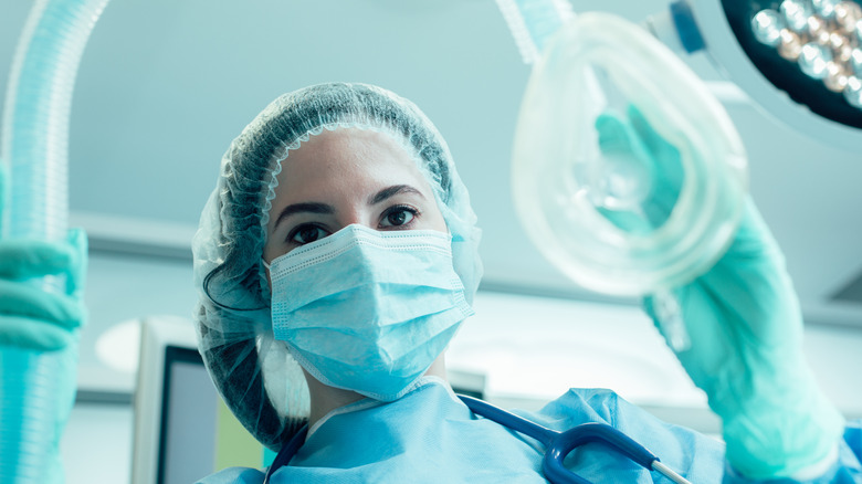 surgeon holding anesthesia mask