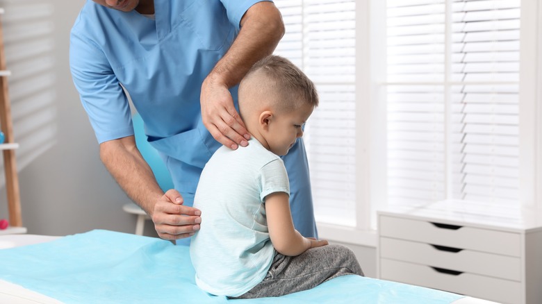 boy getting a back exam