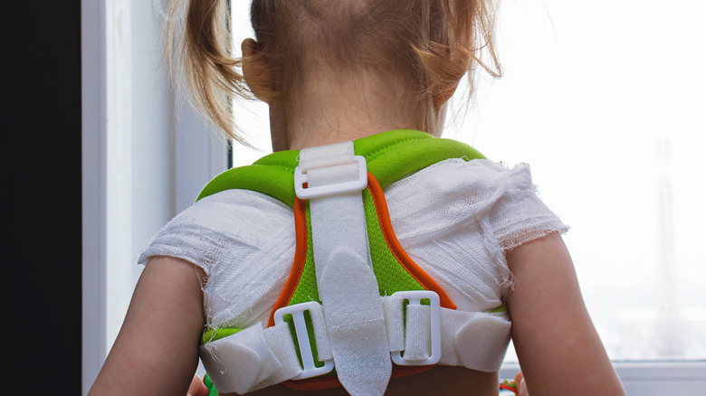 girl wearing back brace