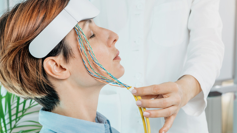 Woman receives neurofeedback therapy