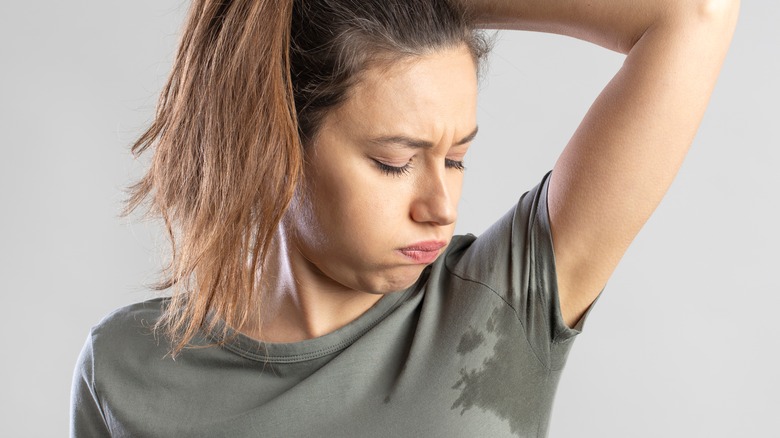 Woman distressed by visible underarm sweat