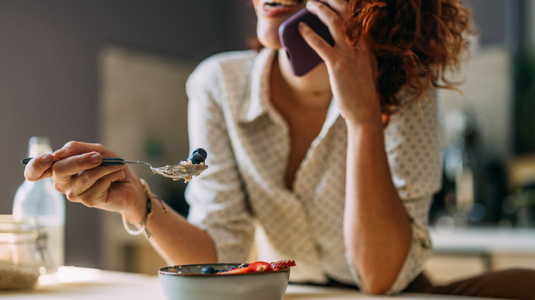 woman eating bowl of oatmeal