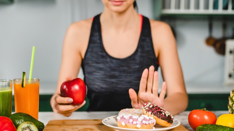 woman saying no to sugary snack