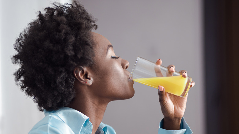 woman drinking a glass of juice