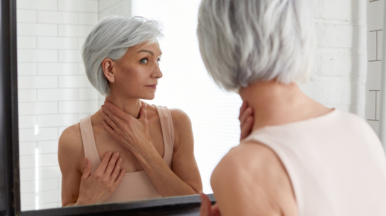 older woman looking in mirror