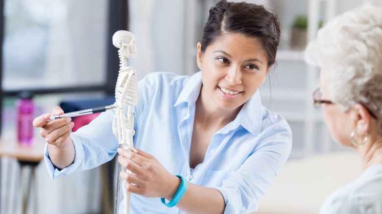 woman doctor talking with older female patient about bone health