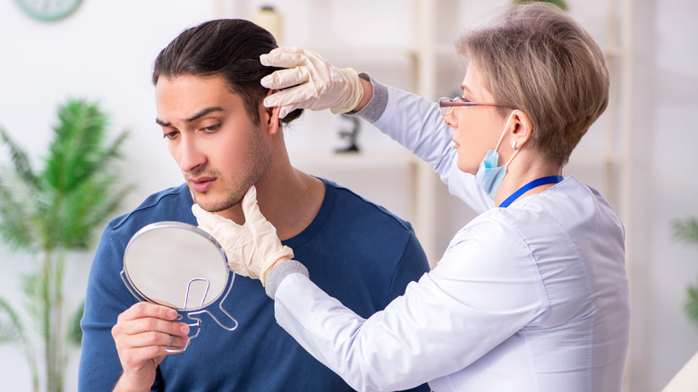 male patient being examined by female doctor