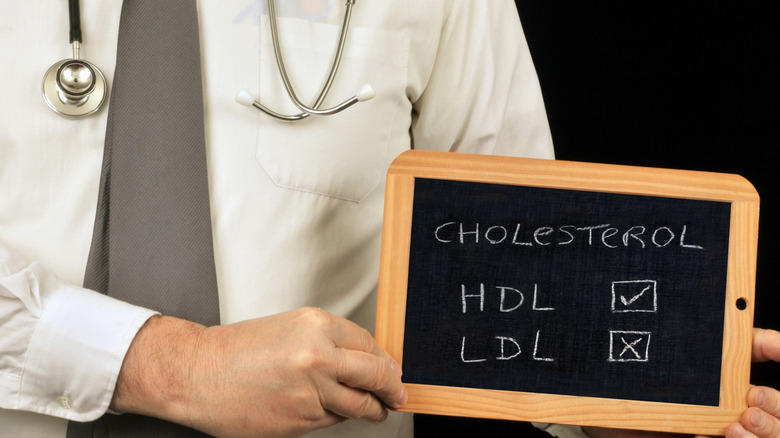 doctor holding board with hdl and ldl cholesterol