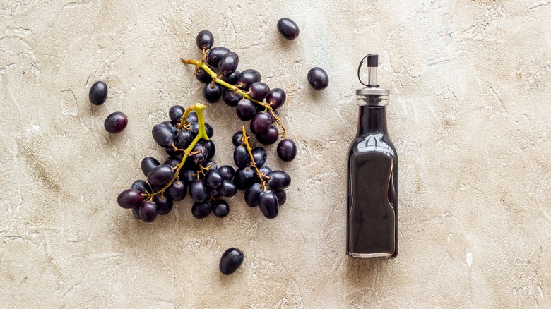 red wine vinegar and grapes on counter