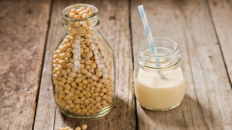 bottle of soybeans next to soymilk