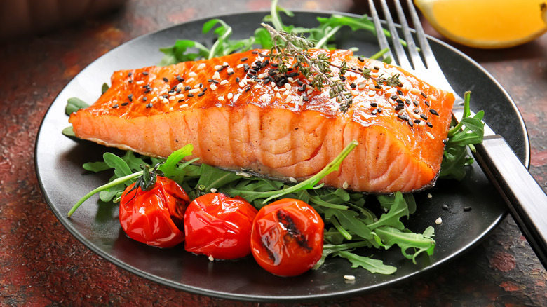 salmon fillet on black plate