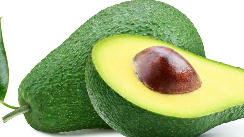 full avocado and sliced open avocado