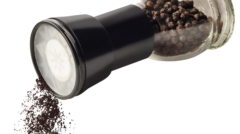 pepper mill with black peppercorns 