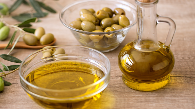 fresh olives and bottle of olive oil
