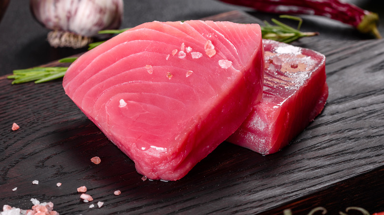 tuna steaks on wooden board