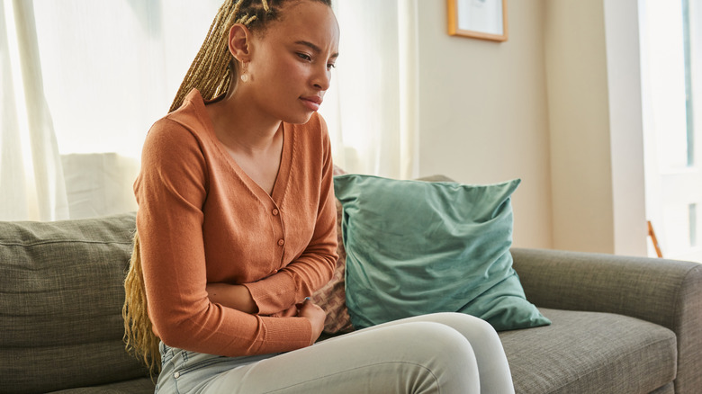 Woman holding stomach in pain