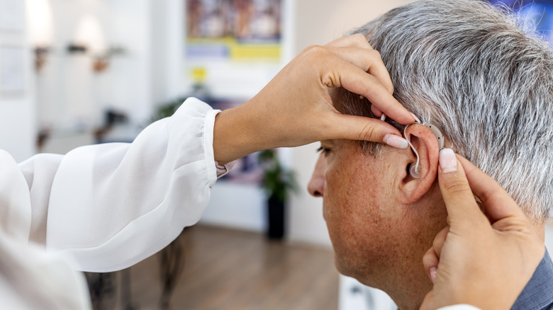 man being fitted for a hearing aid