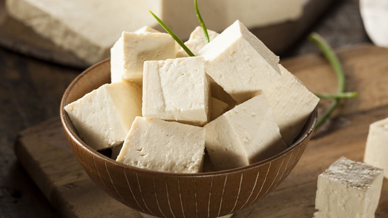 Tofu cubes in wooden bowl