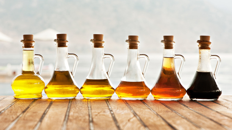 bottles of olive oils and vinegars on a table