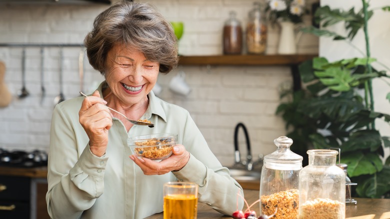 older woman eating cereal