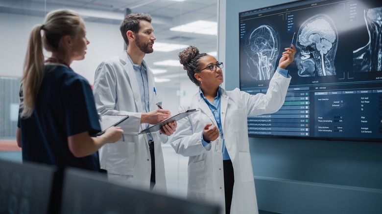 Doctors looking at an image of a brain