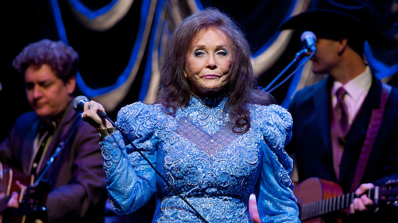 Loretta Lynn performing in blue dress