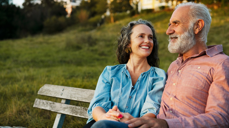 smiling couple sitting outside